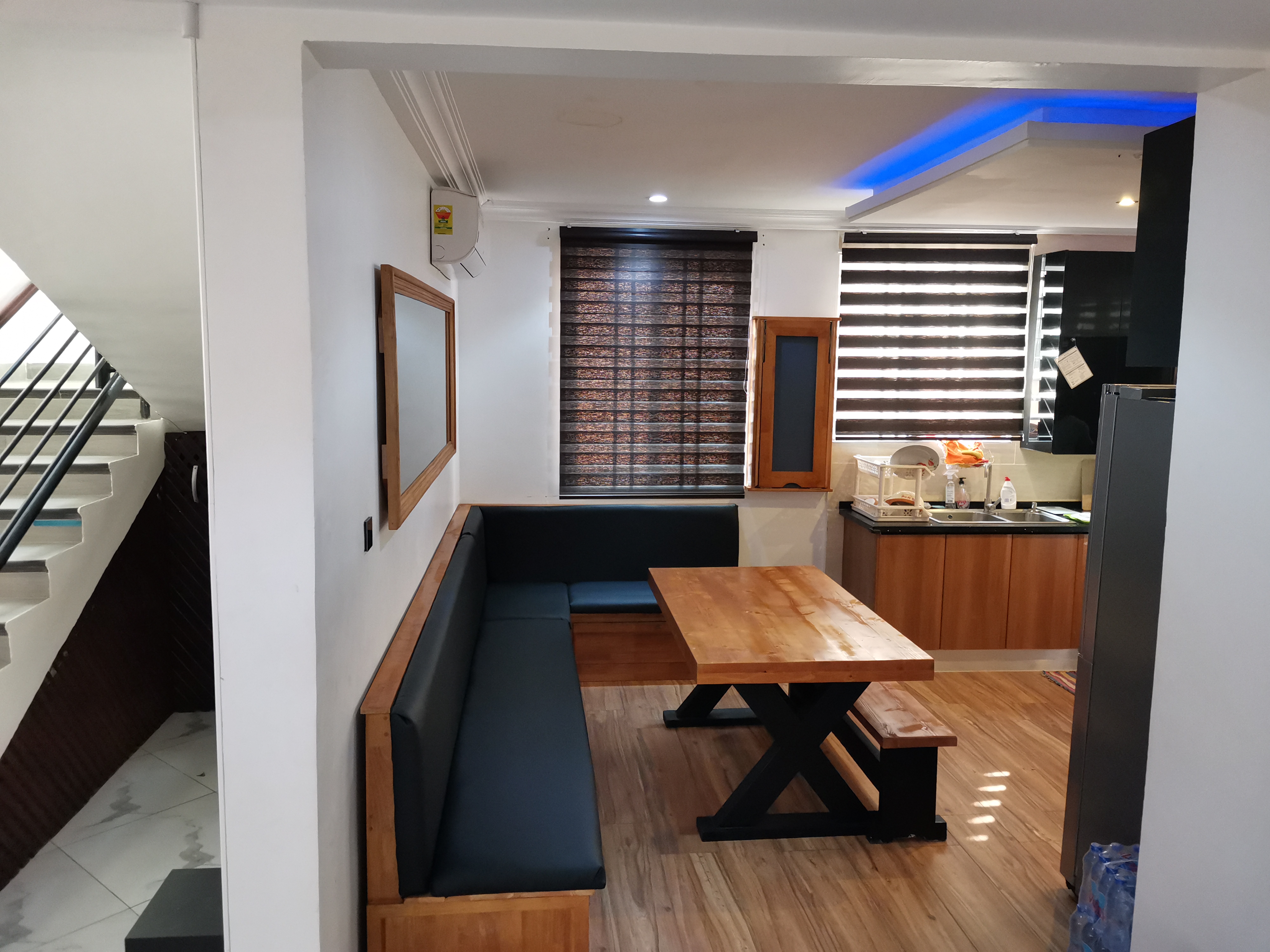 X-frame pine dining table and built-in banquette, Golf Hills Estate, Accra